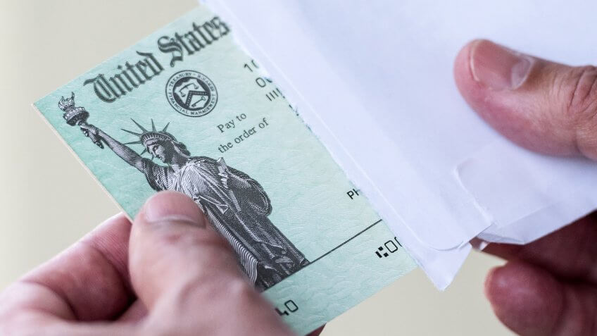 Men hands holding a US Government Treasury check.