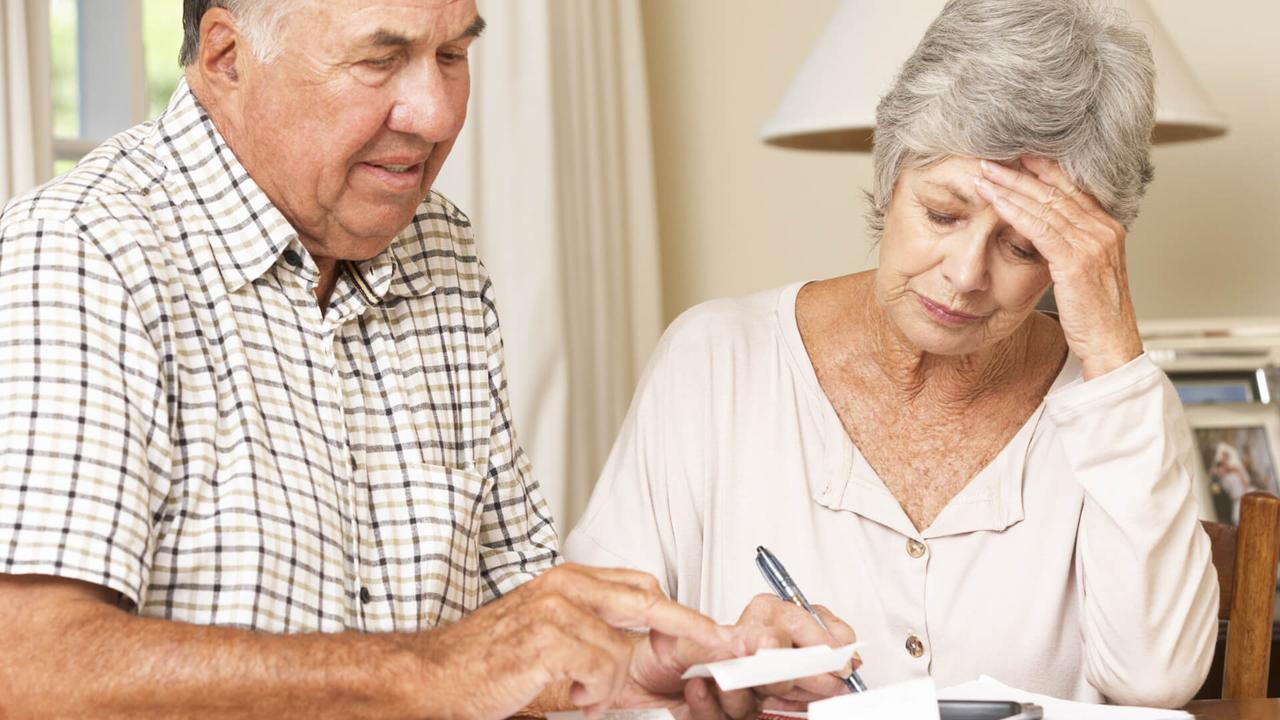 Senior Couple Concerned About Debt Going Through Bills Together.