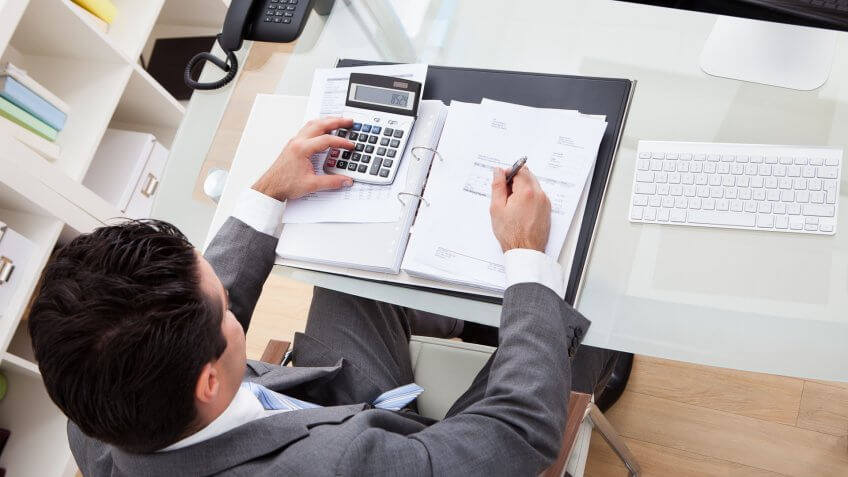 11902, Horizontal, man working on financial documents