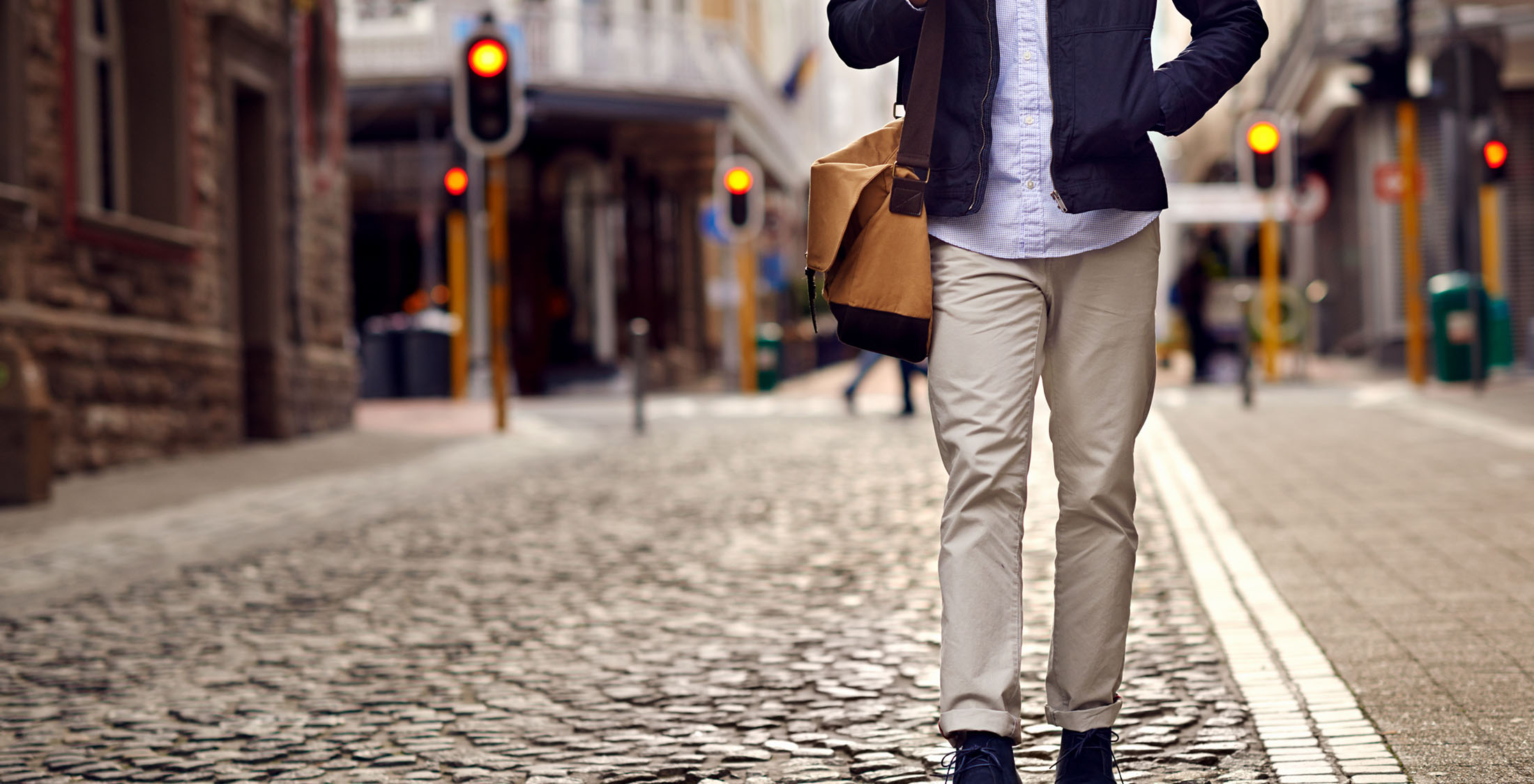 Dress like someone successful. man walking down cobblestone street