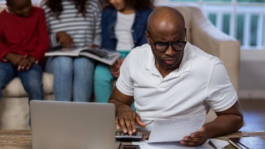 11902, Horizontal, african american man reviewing utility bill