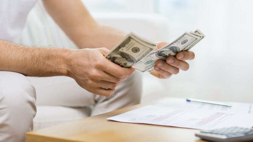 11902, Horizontal, man counting USD money