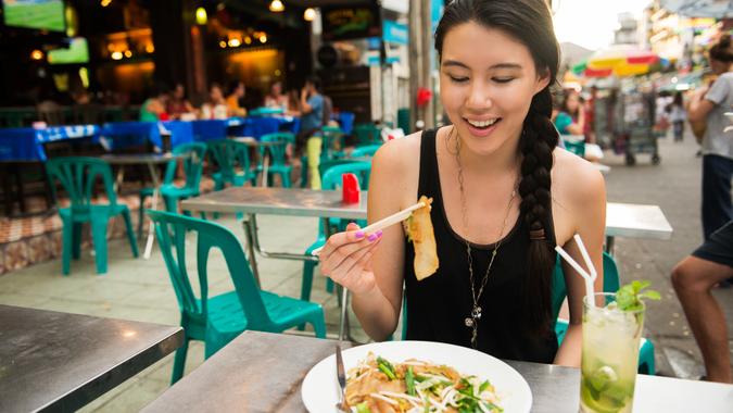 Solo female traveler has fun on Khao San Road in Bangkok, Thailand.