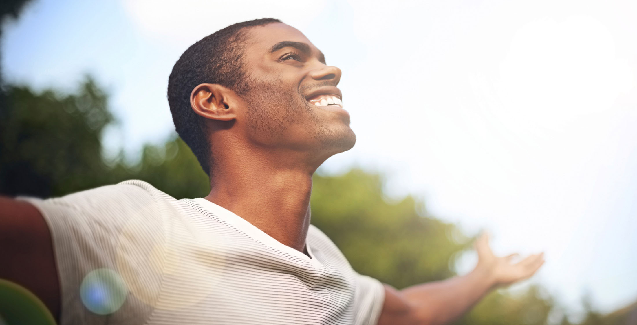 man smiling and spreading arms