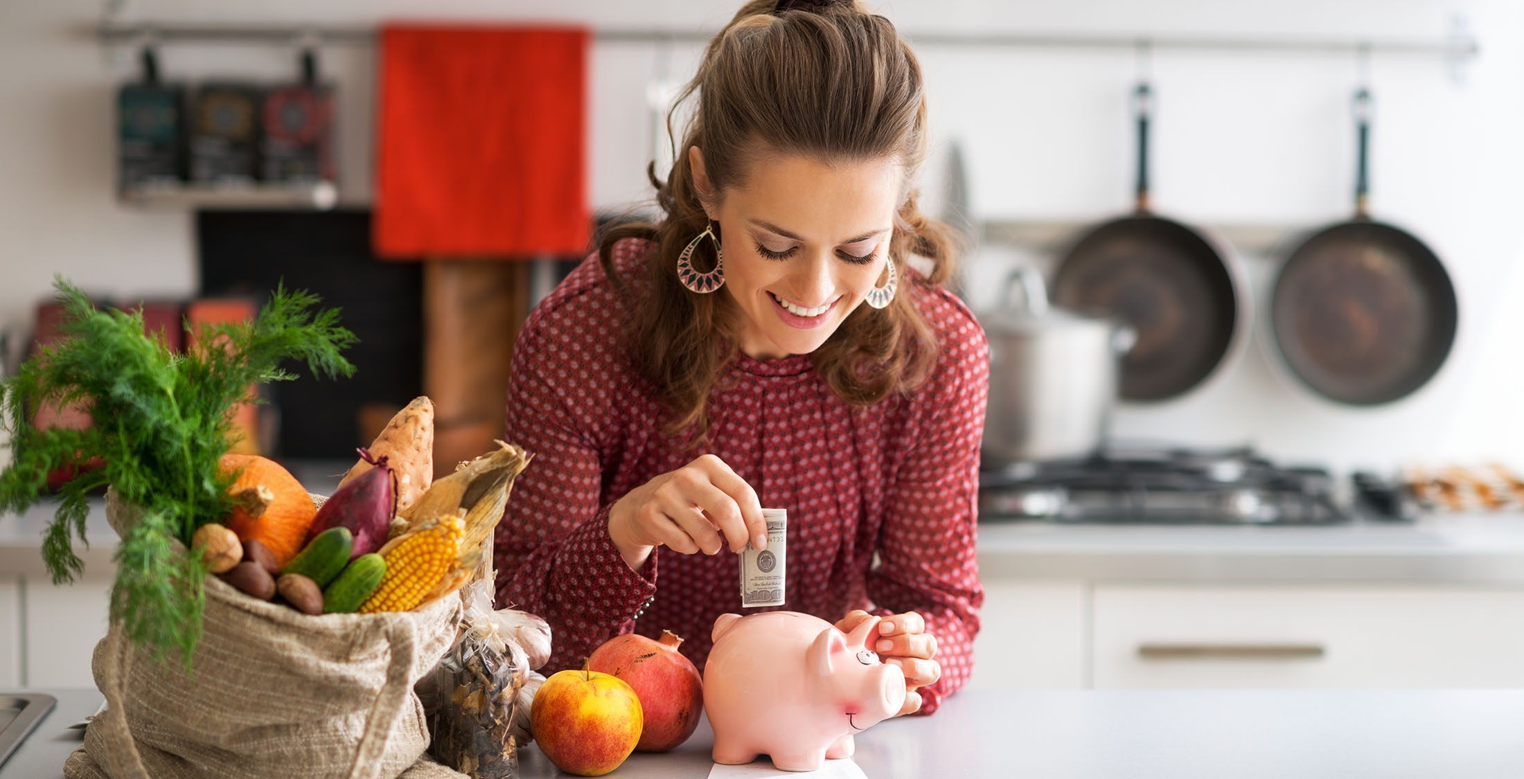 Live within your means. woman putting money into a piggy bank