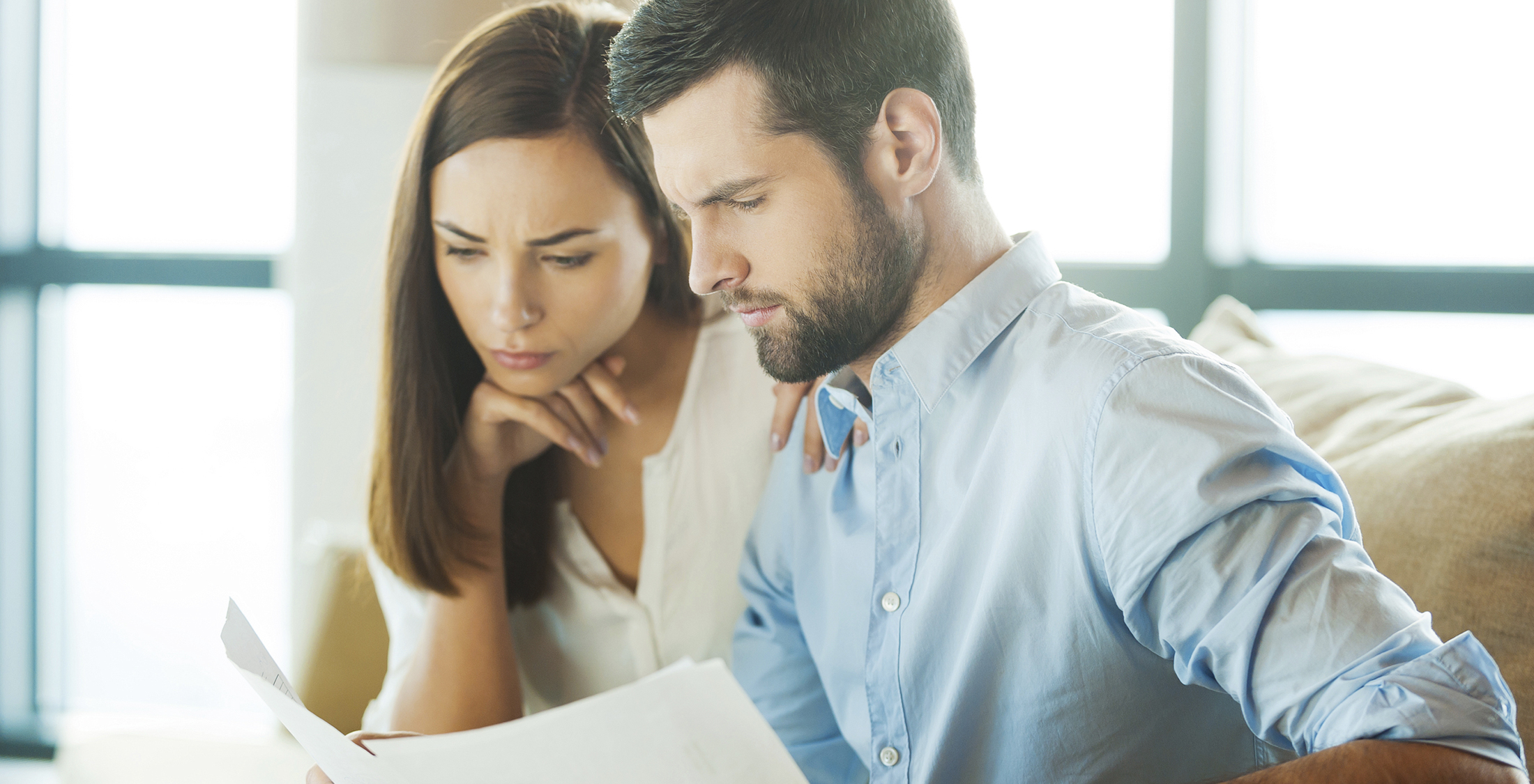 man holding documents and looking at them with woman