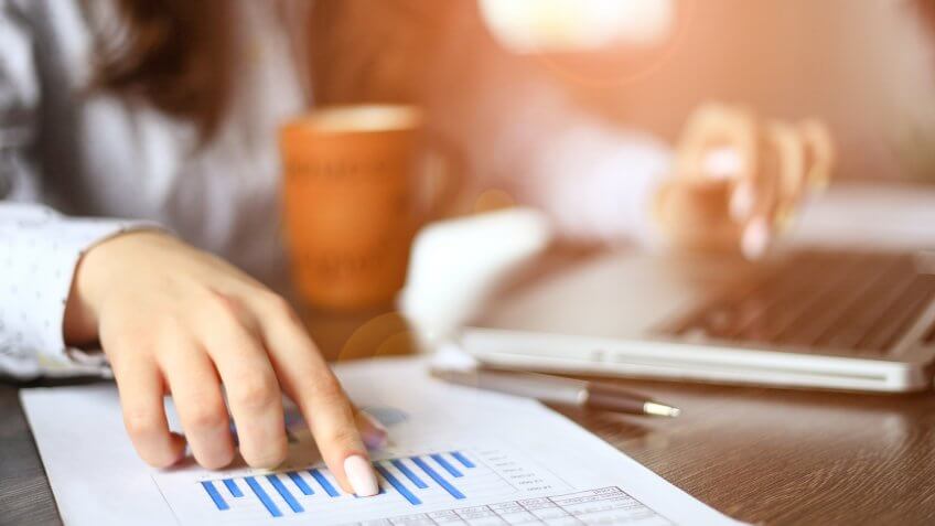Create a budget. woman pointing at bar graph