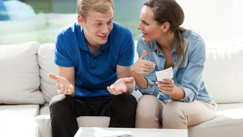 man and woman arguing looking at a piece of paper
