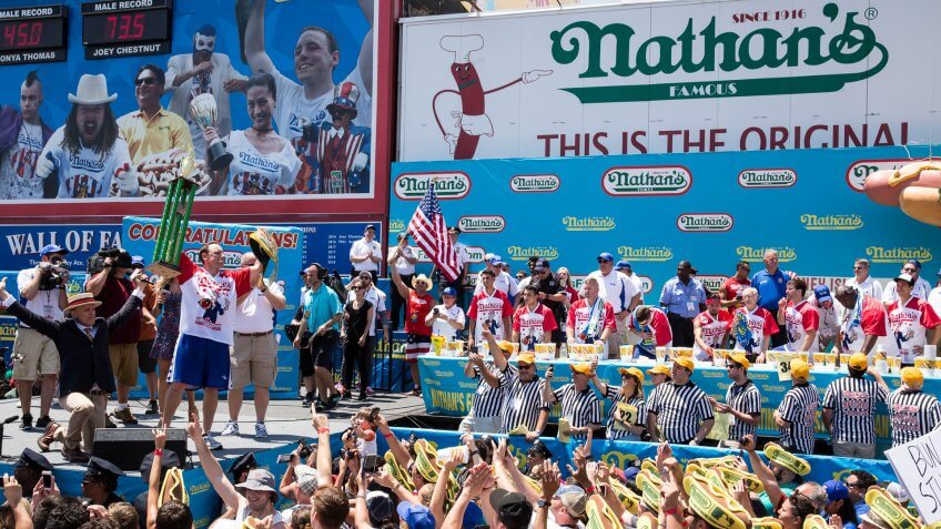 NEW YORK, NY - JULY 04: Joey Chestnut (L) is declared the winner of the 2017 Nathan's Famous International Hot Dog Eating Contest for this 10th title overall after eating 72 hot dogs in 10 minutes at Coney Island on July 4, 2017 in the Brooklyn borough of New York City.
