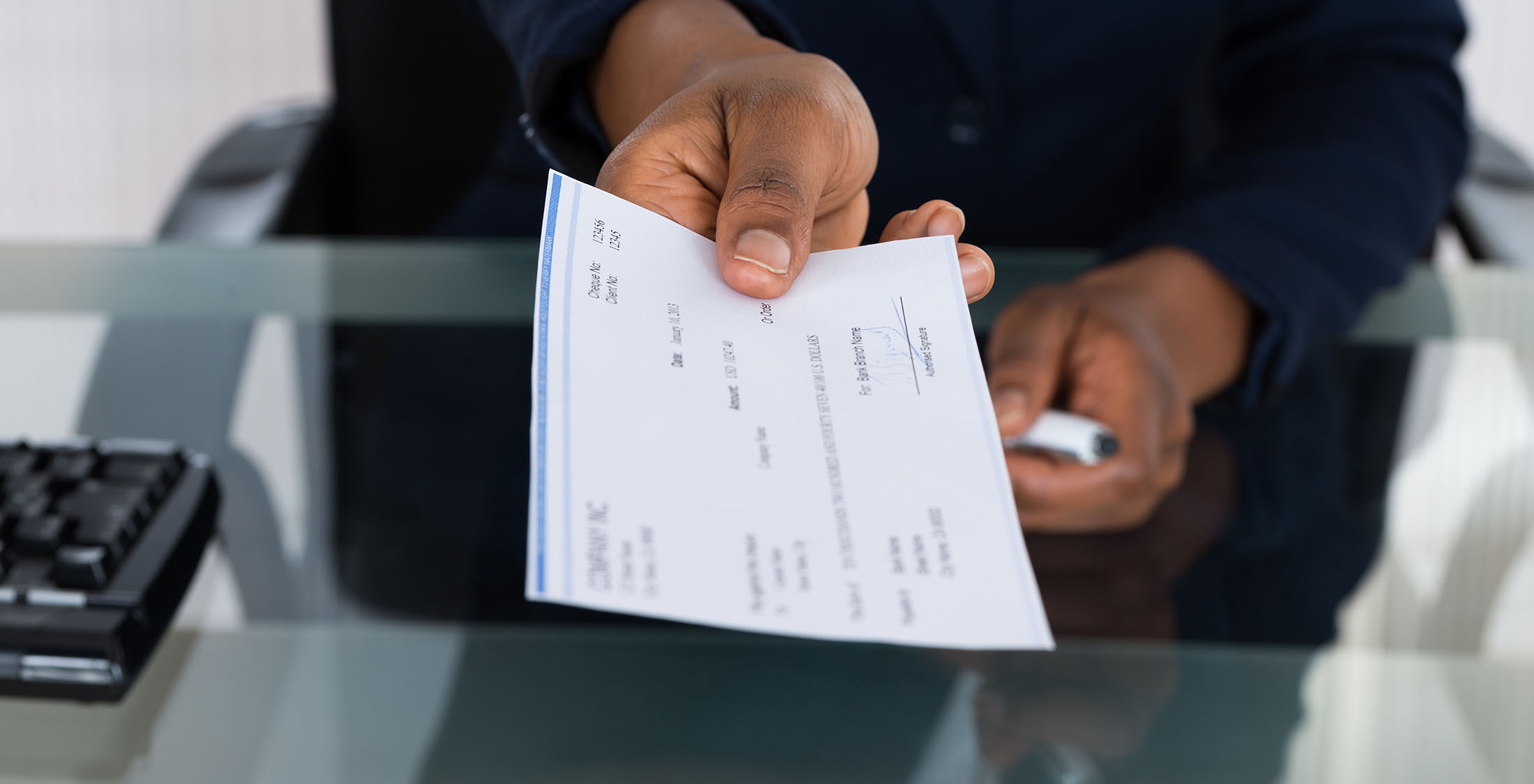 No need to take a pay cut. person handing over a check