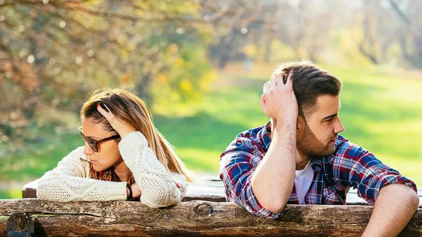 man and woman outside looking away from each other
