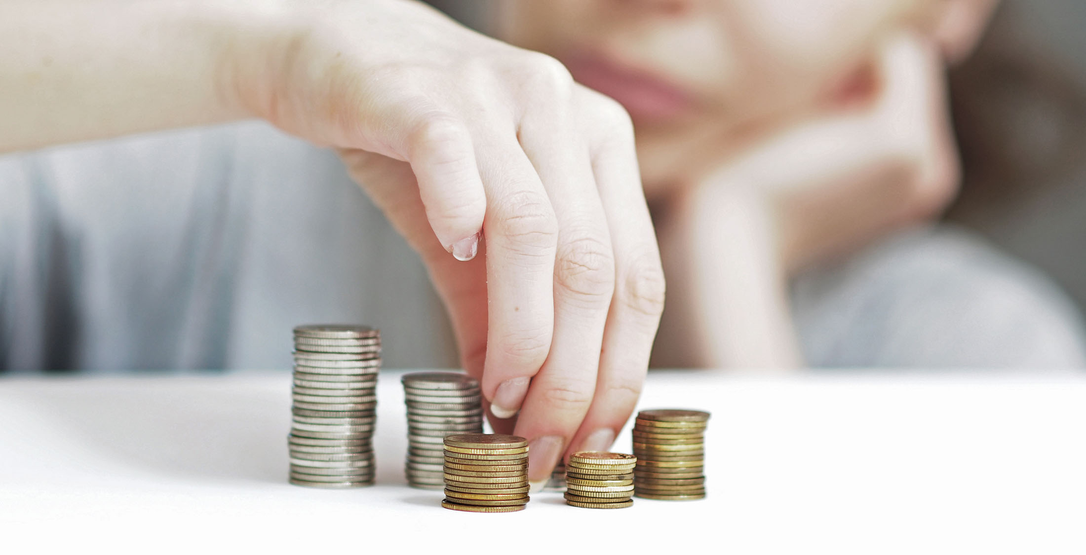 Get your finances in order. woman stacking coins