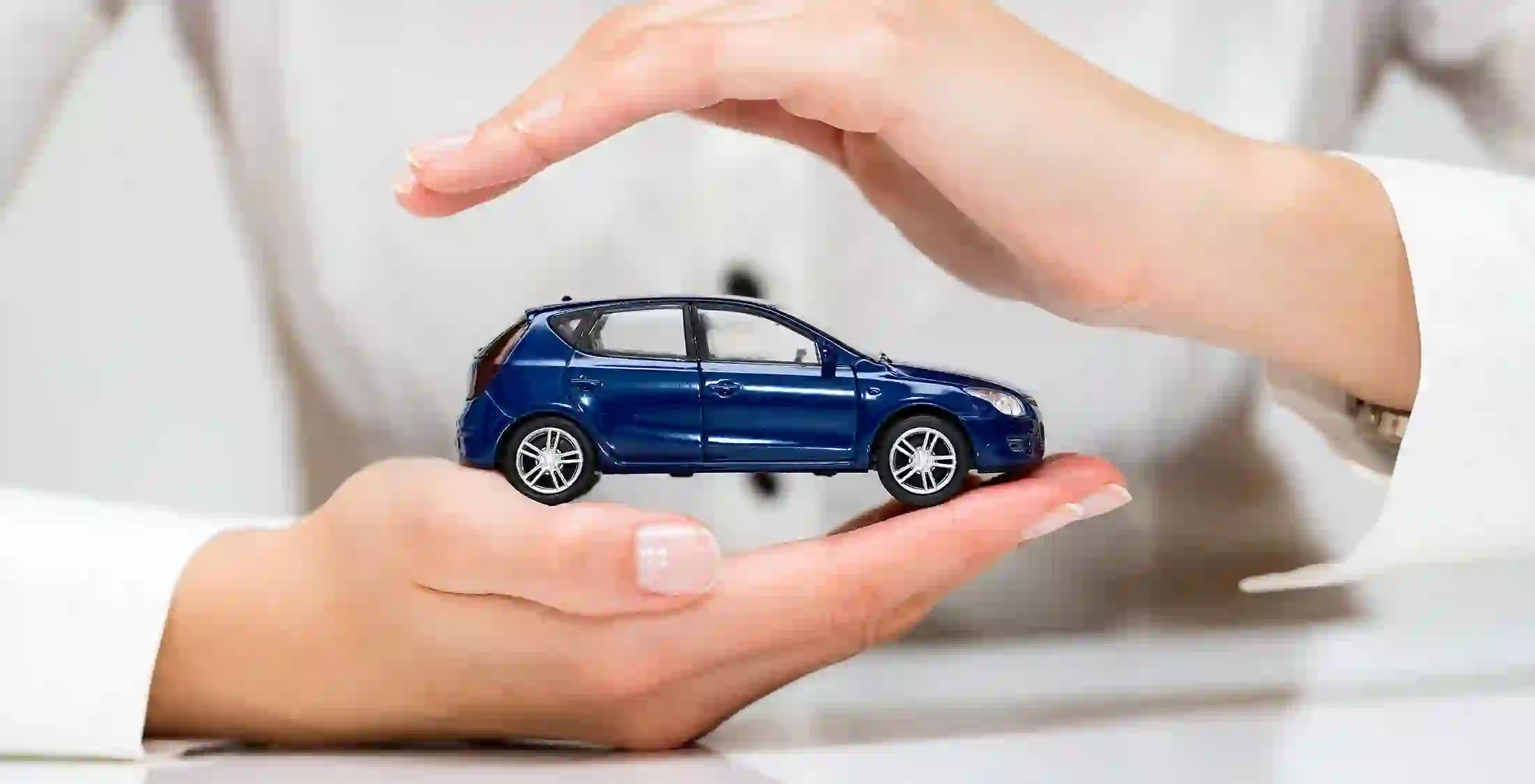 woman holding small car in hands