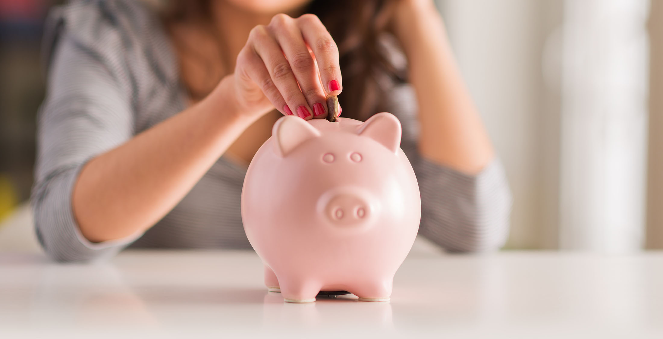 Good credit scores get you better offers and rates. woman insert coin into piggy bank
