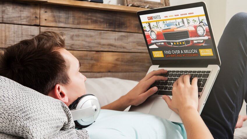 Sell the parts. man doing car research on laptop