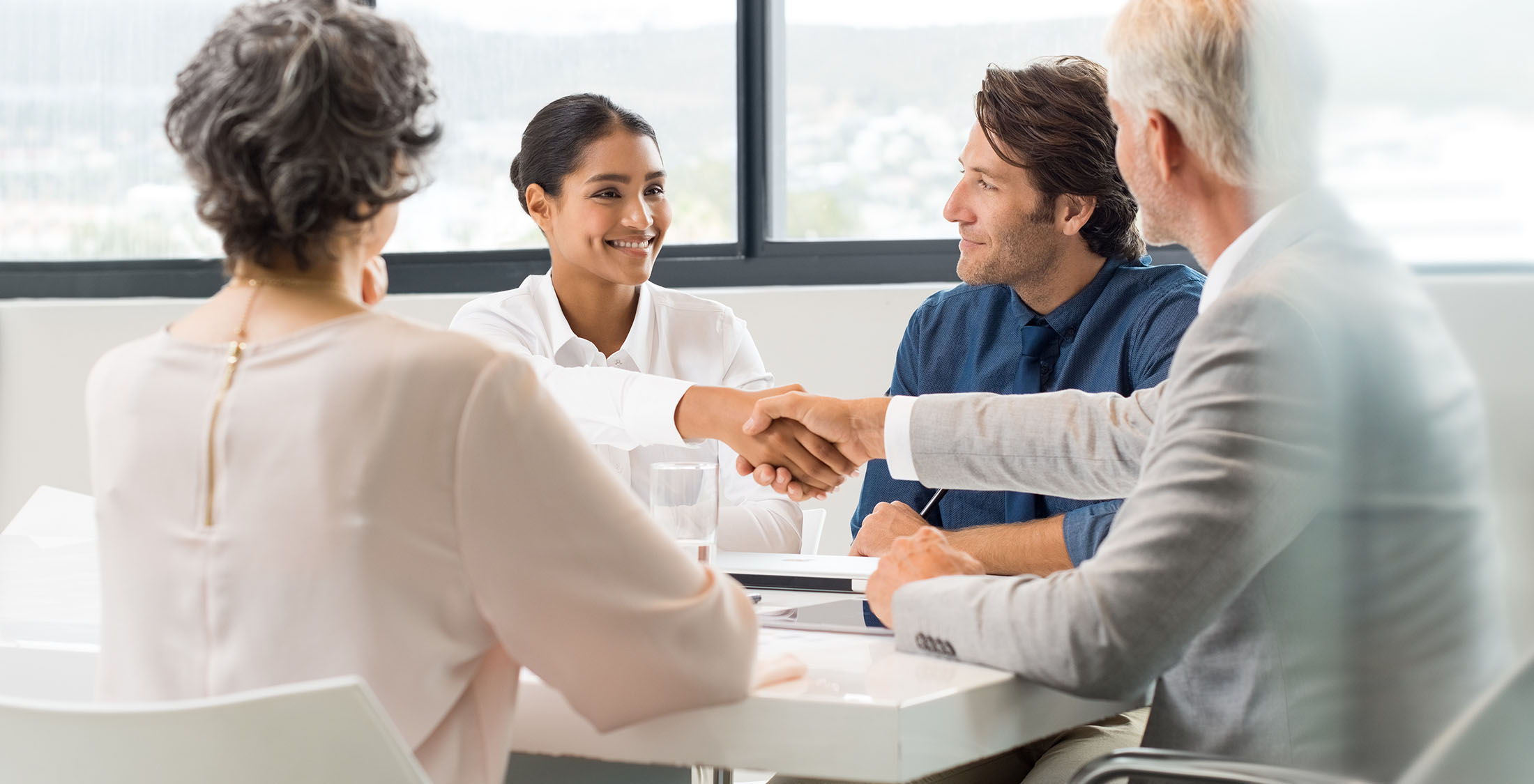You spend your entire raise. businesswoman shaking businessman's hand