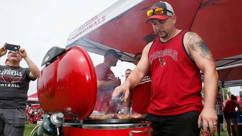 GLENDALE, AZ - SEPTEMBER 13: Shawn Cooper of Avondale, AZ grills before the start of the NFL game between the Arizona Cardinals and the New Orleans Saints at the University of Phoenix Stadium on September 13, 2015 in Glendale, Arizona.