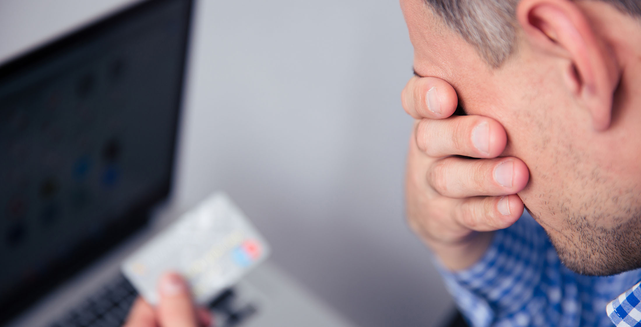 Uncover fraud through your credit score. man upset at credit card