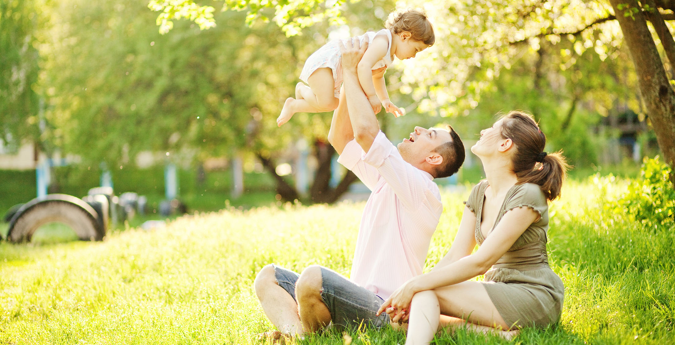 Raising kids is less financially stressful. couple playing with baby