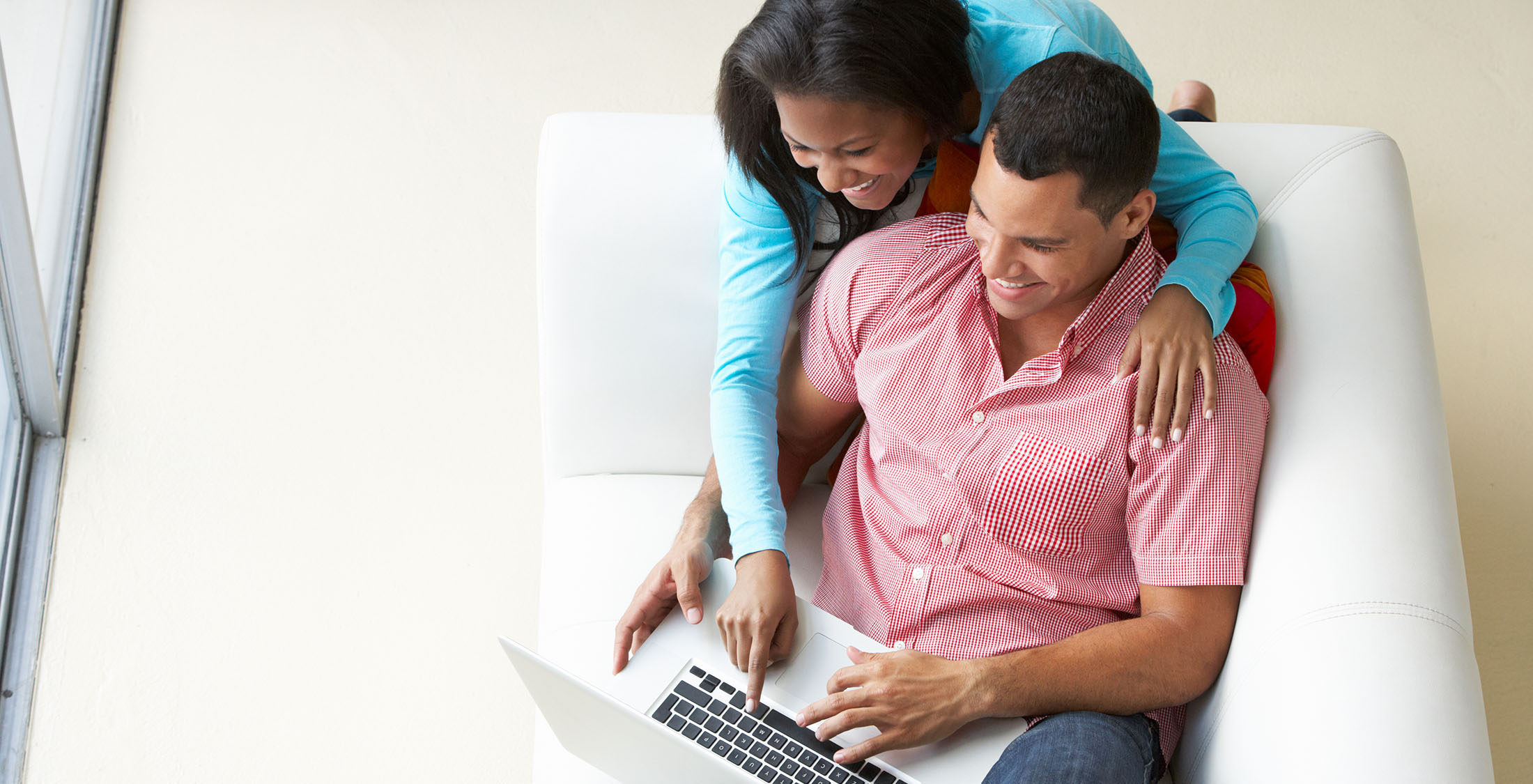 Do your homework on car prices. couple looking at something on laptop