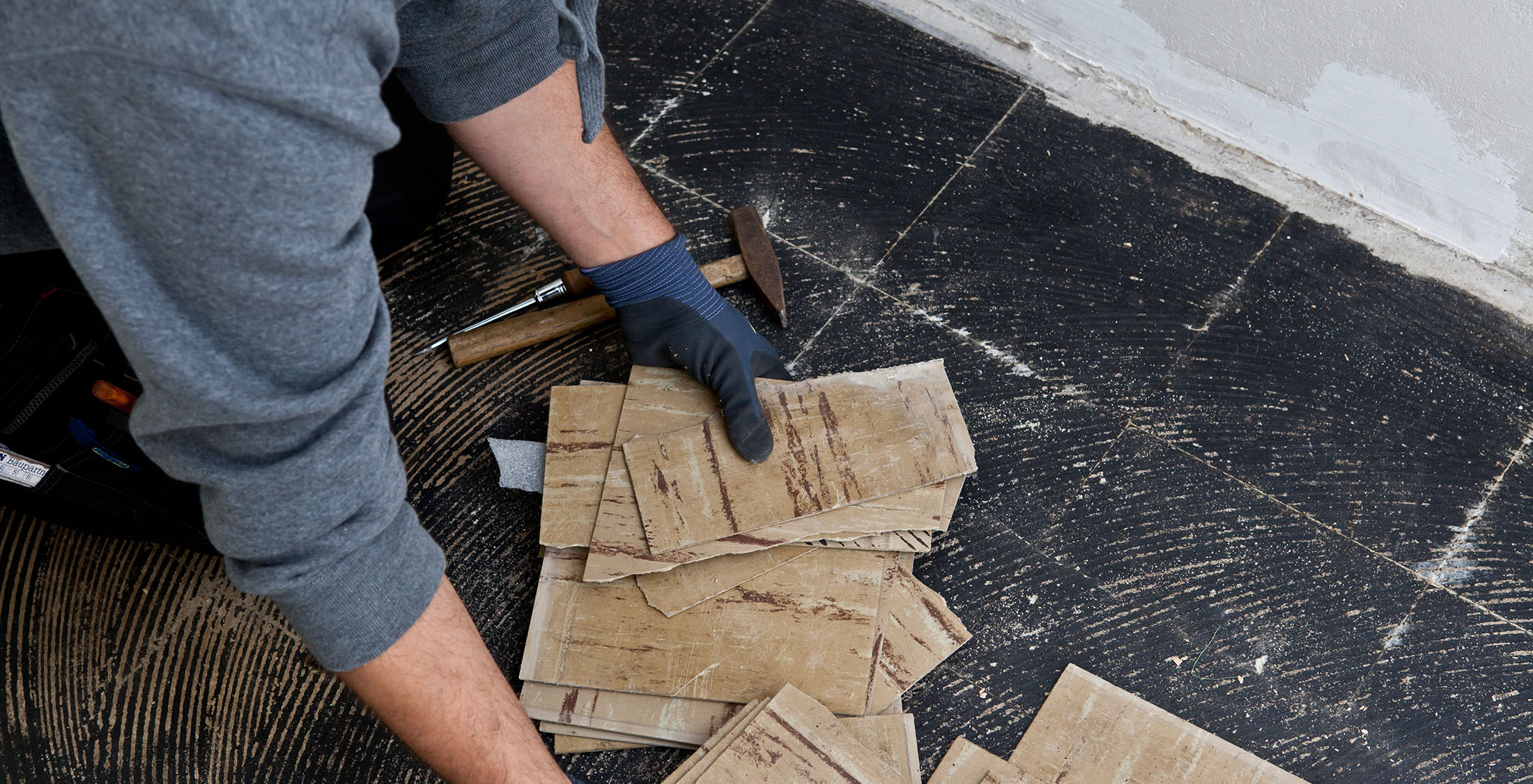 Lay down new vinyl tiles construction worker renovating flooring
