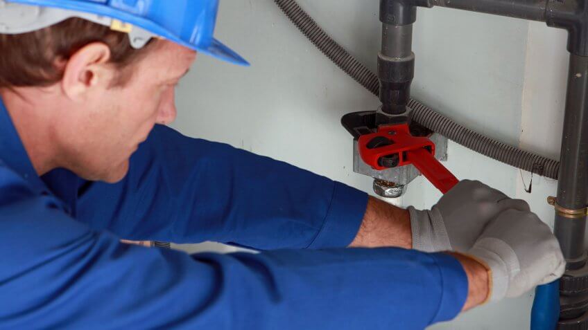 plumber fixing pipes