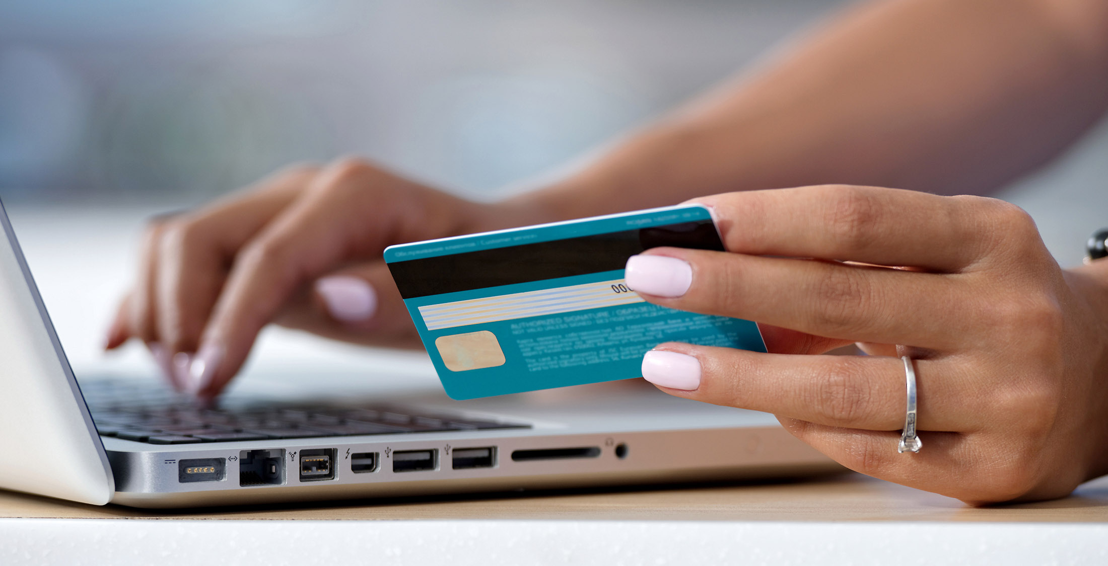 Keep a record of timely payments. woman typing credit card info into laptop