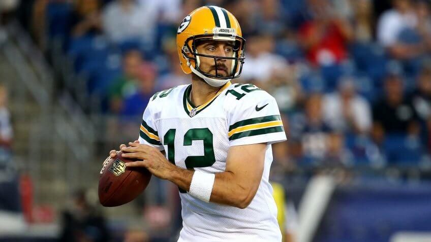 FOXBORO, MA - AUGUST 13: Aaron Rodgers #12 of the Green Bay Packers drops back to pass in the first quarter against the New England Patriots during a preseason game at Gillette Stadium on August 13, 2015 in Foxboro, Massachusetts.