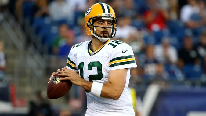 FOXBORO, MA - AUGUST 13:  Aaron Rodgers #12 of the Green Bay Packers drops back to pass in the first quarter against the New England Patriots during a preseason game at Gillette Stadium on August 13, 2015 in Foxboro, Massachusetts.