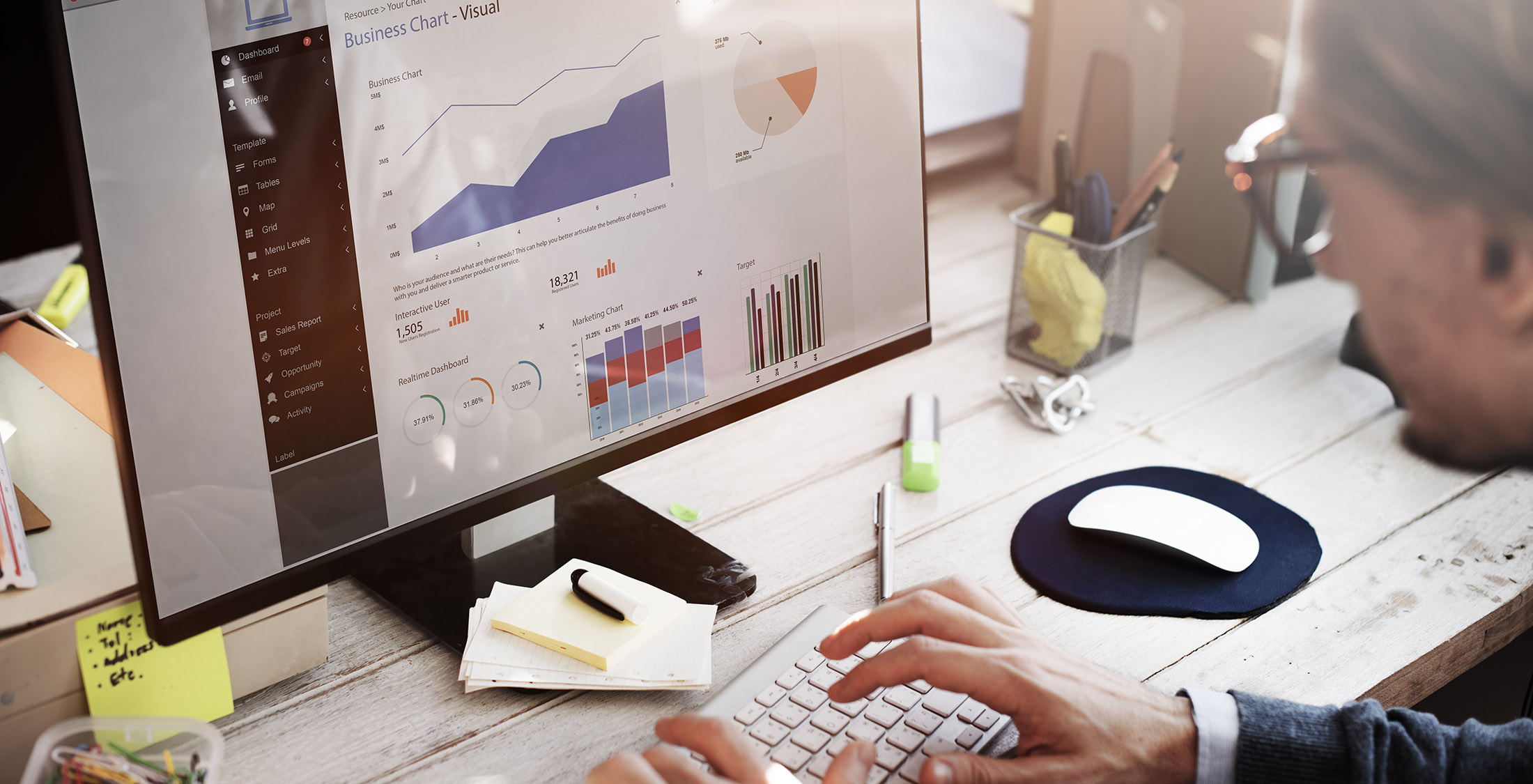 Know your revenue history. person looking over analytics reports on computer screen