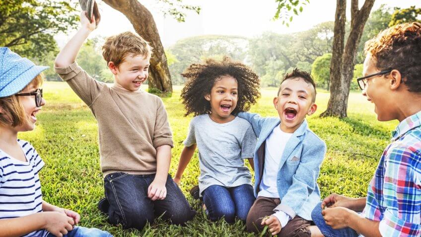 Save for your kids. group of kids sitting in circle laughing