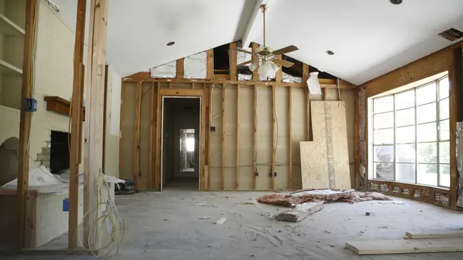 the inside of a home being renovated, showing walls and flooring that needs work
