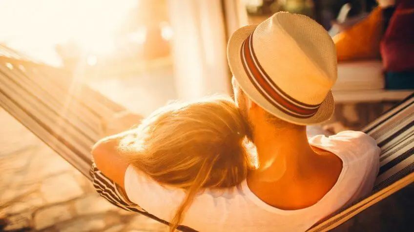 man and woman cuddling on a hammock outside