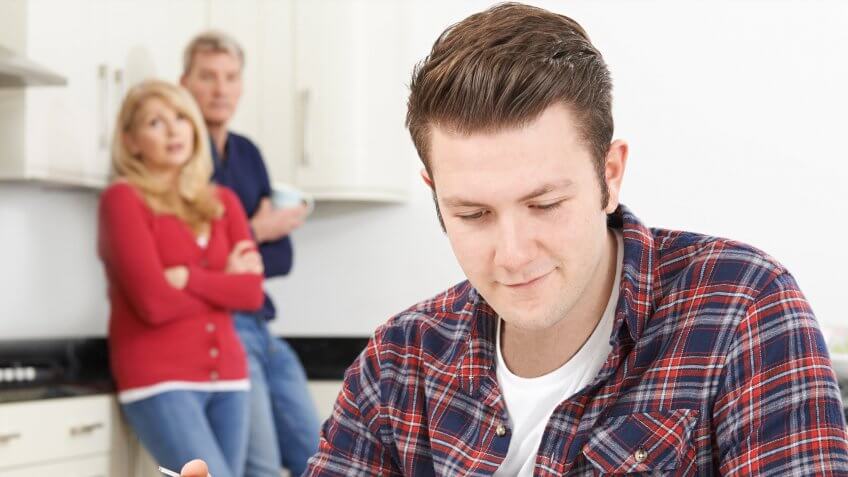 You won't cut off your deadbeat children. parents looking disappointed at oblivious son