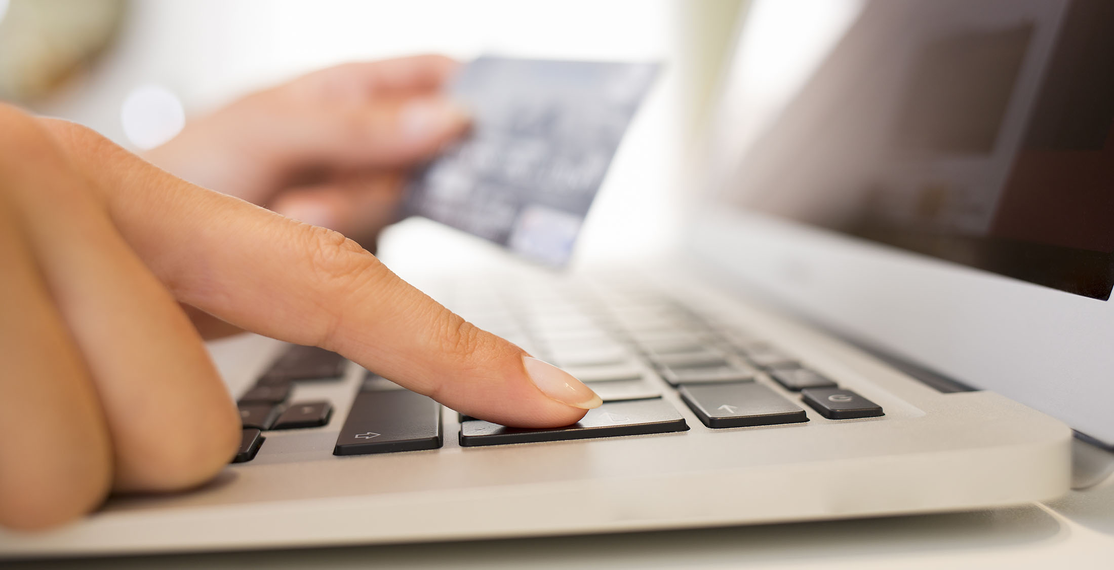 You shuffle credit card balances. person typing credit card info into laptop