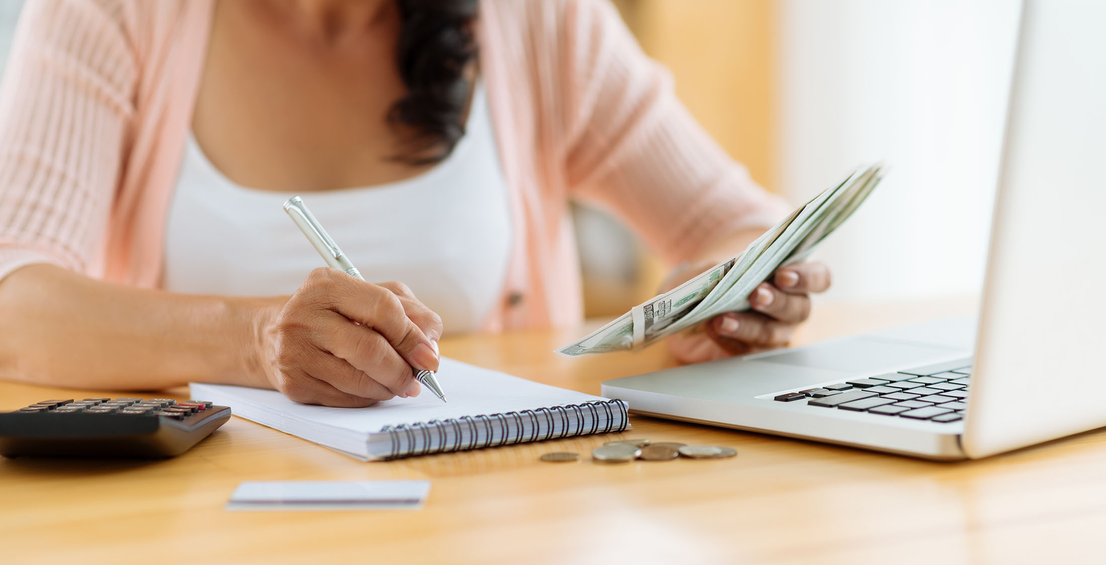 Cut anything that's not important. woman with dollar bills budgeting