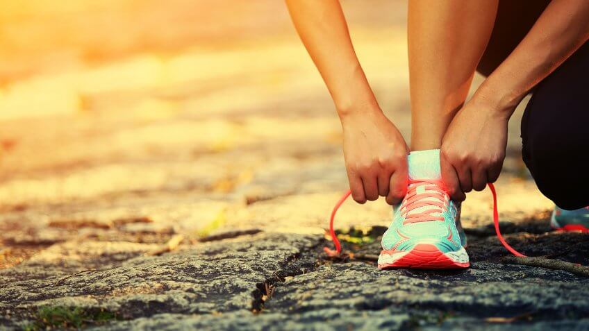 runner tying on running shoes