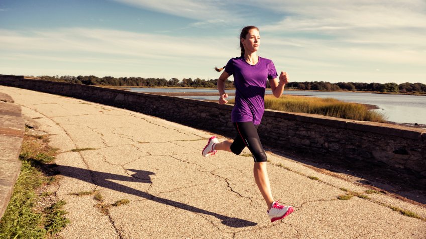 A female runner runs in New England.