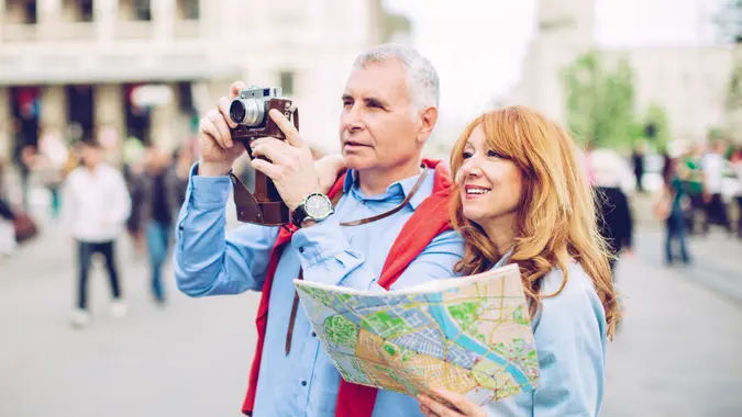 Mature couple embracing outdoors in city street.