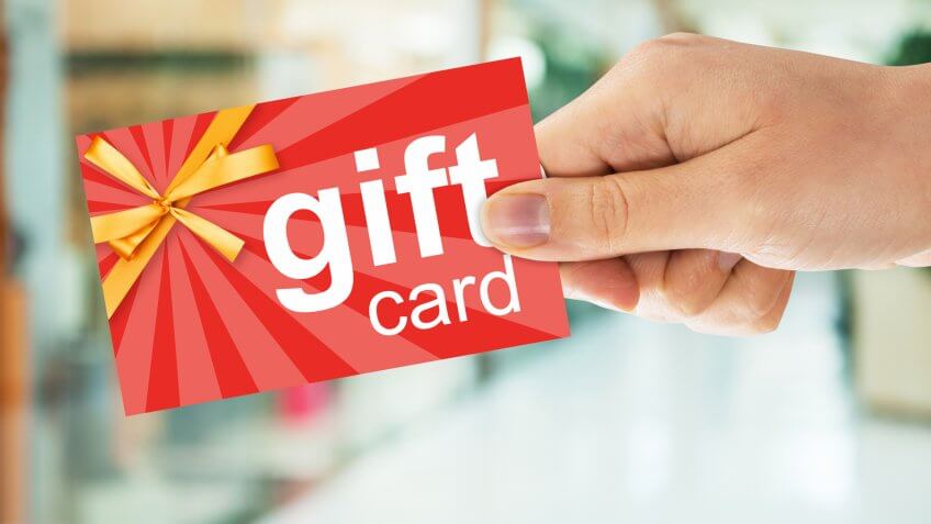 Cropped image of person's hand holding gift card.