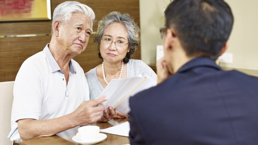 imtmphotoStock photo ID: 538648228senior asian couple looking skeptical during meeting with insurance agent.