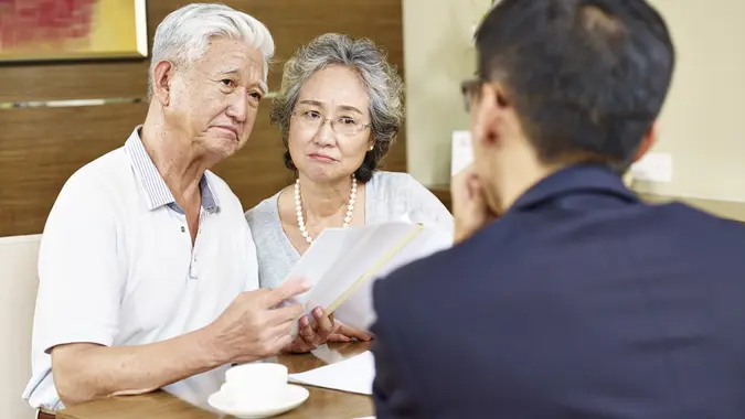 imtmphotoStock photo ID: 538648228senior asian couple looking skeptical during meeting with insurance agent.