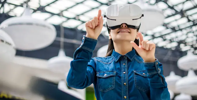 girl wearing vr headset and pointing