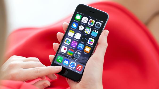 Woman holding new iPhone 6 Space Gray in the hand.