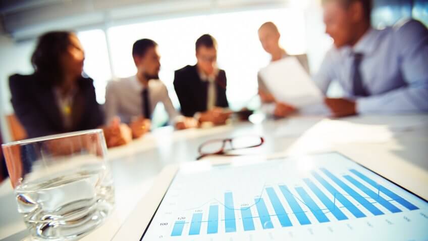 coworkers in meeting with focus on chart
