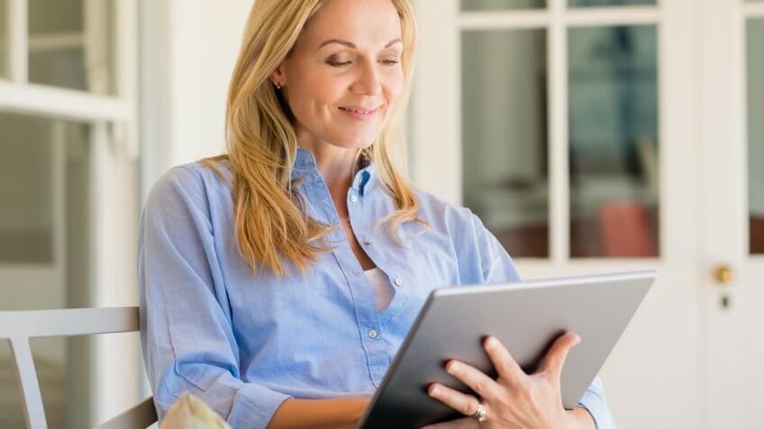 Portrait of a business woman using digital tablet in open air porch.