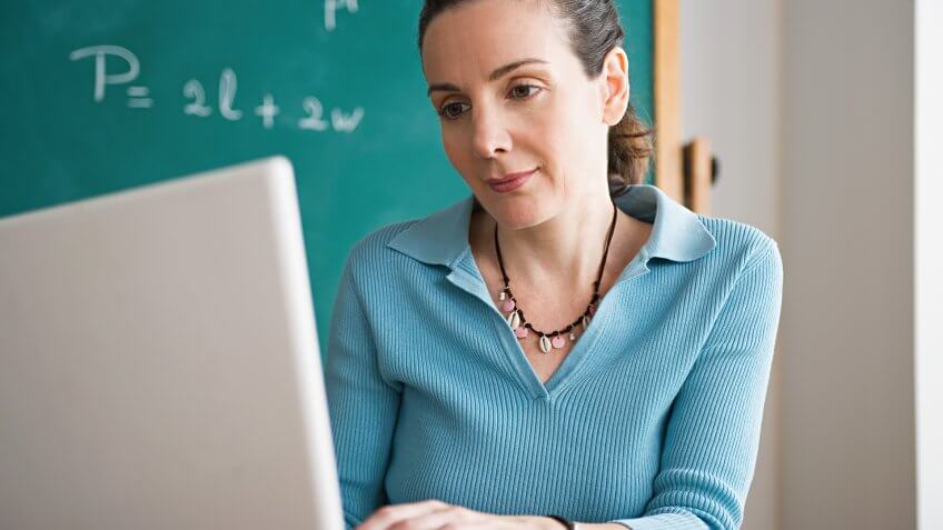 40-44 Years, Beauty, California, Confidence, Day, Education, Enjoyment, Happiness, Head And Shoulders, Horizontal, Indoors, Laptop, Los Angeles, One Mature Woman Only, One Person, Side View, Teacher, Typing, USA, Using Laptop, Wireless Technology