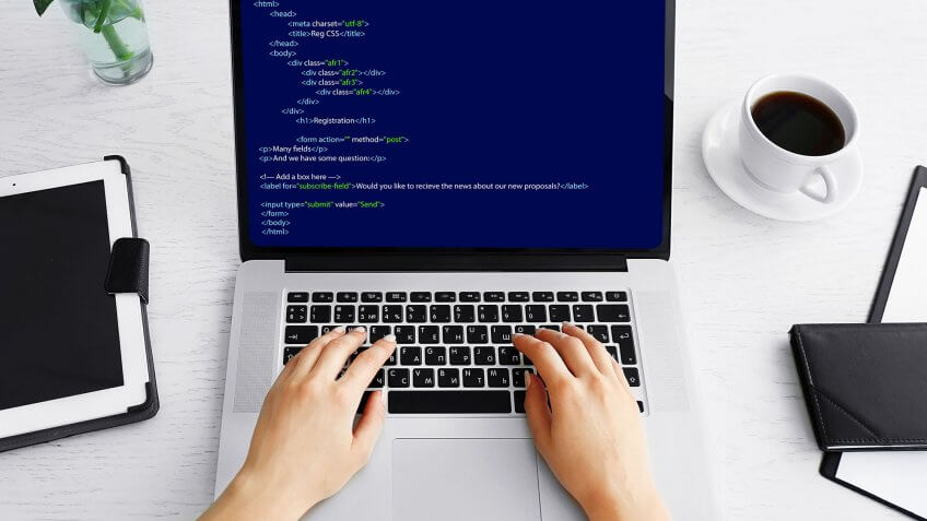 person coding on laptop