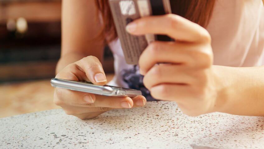 Freeze any cards you don't plan to use. person typing on phone