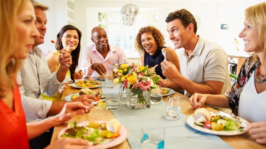 Group of adults eating together Group of adults eating together